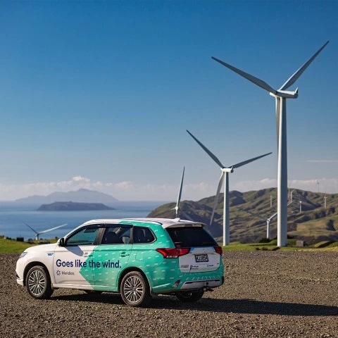 Meridian car in front of a wind farm